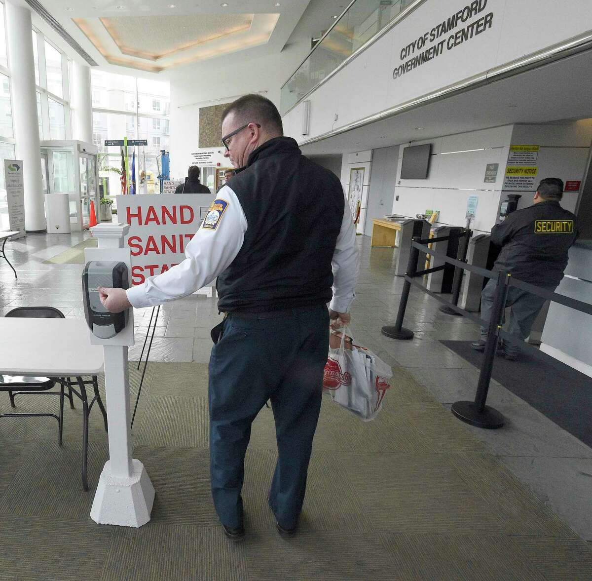 A city employee uses a hand sanitizer station as they enter the Stamford Government Center on March 11, 2020 in Stamford, Connecticut. Stamford Mayor David Martin implemented this past Friday, everyone must hand sanitize before entering city buildings due to COVID-19 Coronavirus outbreak.