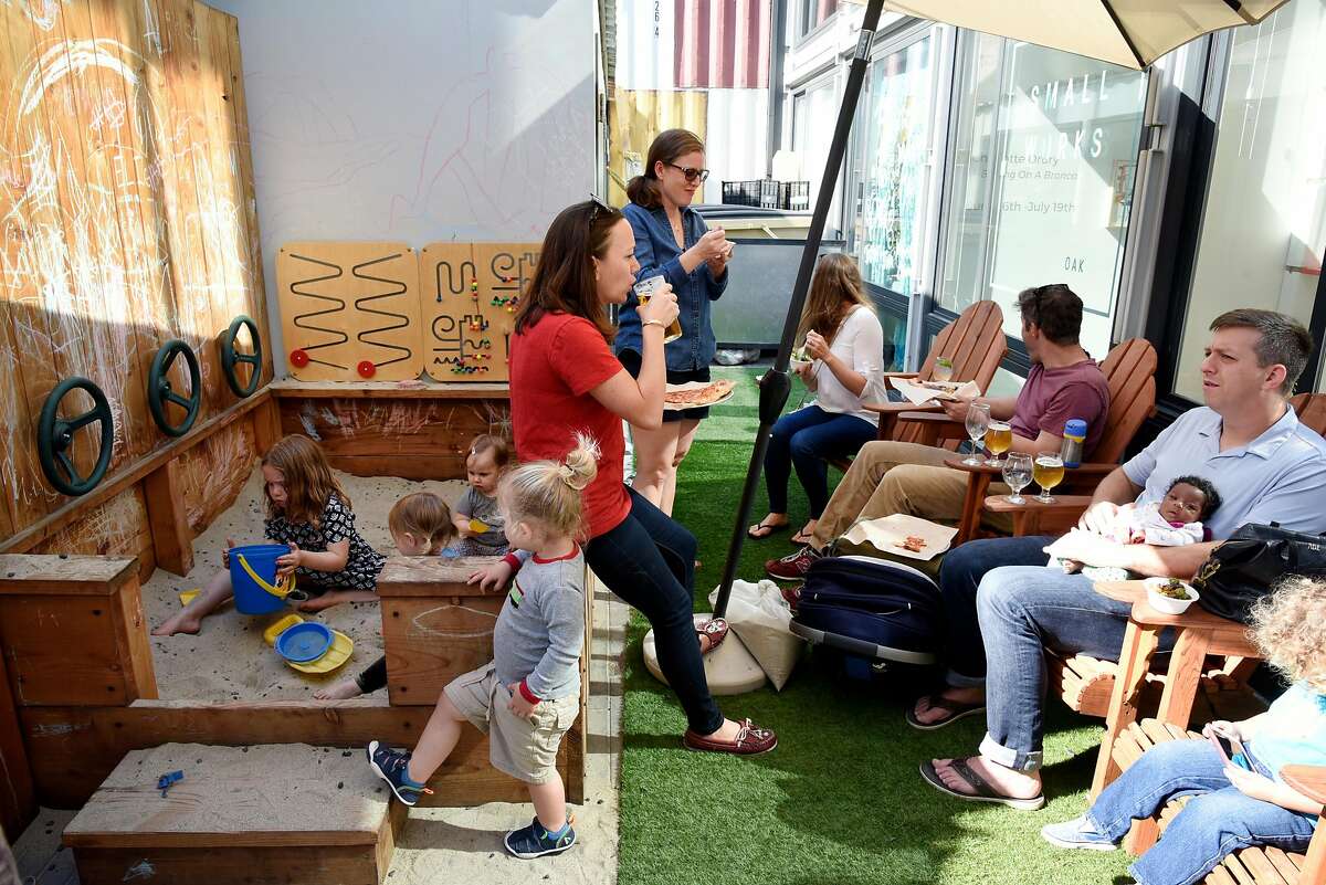 Children play in a sandbox as parents socialize at Arthur Mac's Tap and Snack beer garden in Oakland, CA, on Saturday June 24, 2017.