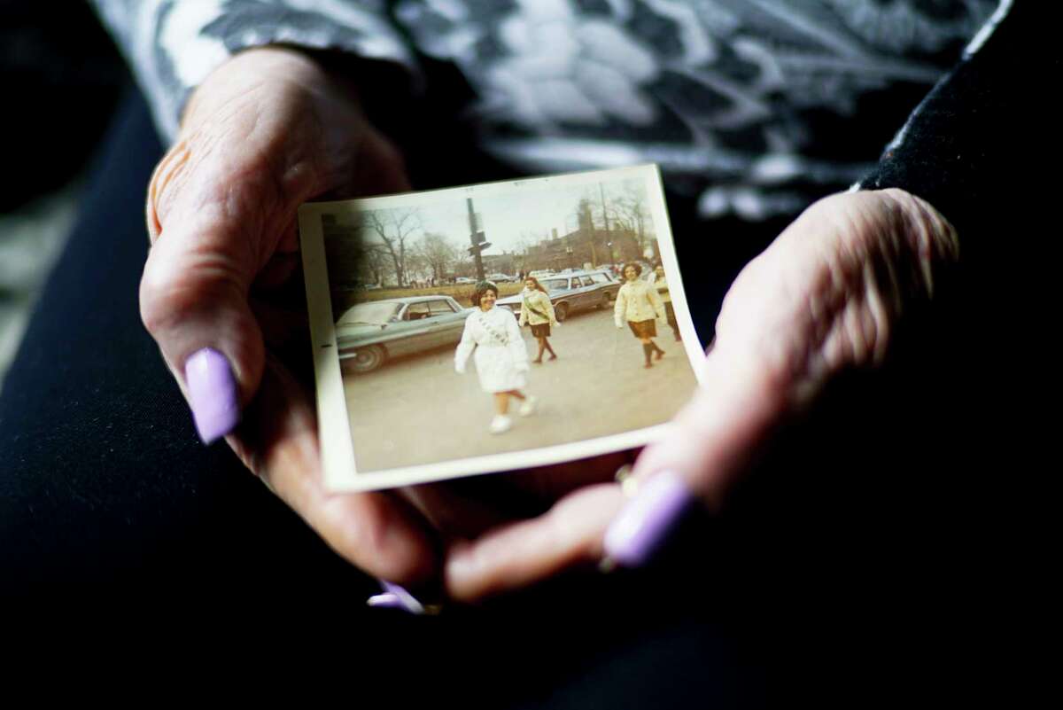 Alice Burke holds a photo of herself marching in the Albany St. Patrick's Day Parade in 1969 at her home on Thursday, March 12, 2020, in Colonie, N.Y. Burke has marched in the parade for the last 55 years. (Paul Buckowski/Times Union)