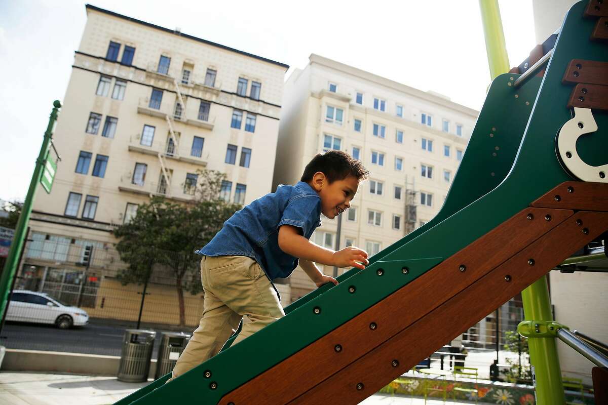 Cesar Arqueta, 3, climbs up the slide before sliding down it as he plays at the new Turk and Hyde Mini Park on Thursday, March 5, 2020 in San Francisco, Calif.