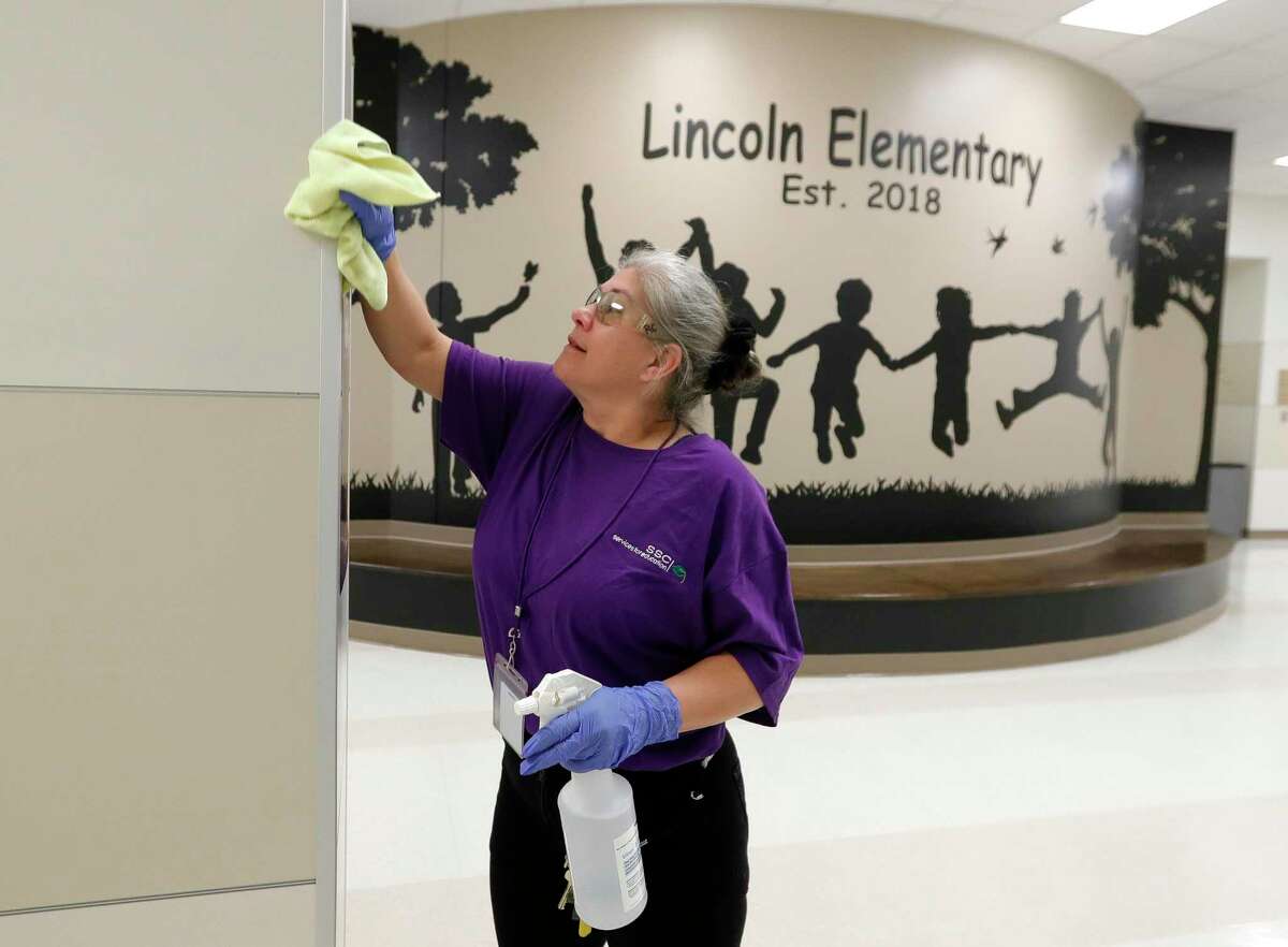 Custodian Ranae Cox works to clear Lincoln Elementary School, Thursday, March 12, 2020, in Montgomery. Members of Montgomery ISD’s service for education management began additional disinfectant steps at all of the district’s 10 schools. Superintendent Beau Rees announced the district would close two days ahead of spring break in an abundance of caution after health officials announced Montgomery County’s first ‘presumptive positive’ case of the coronavirus on March 11.