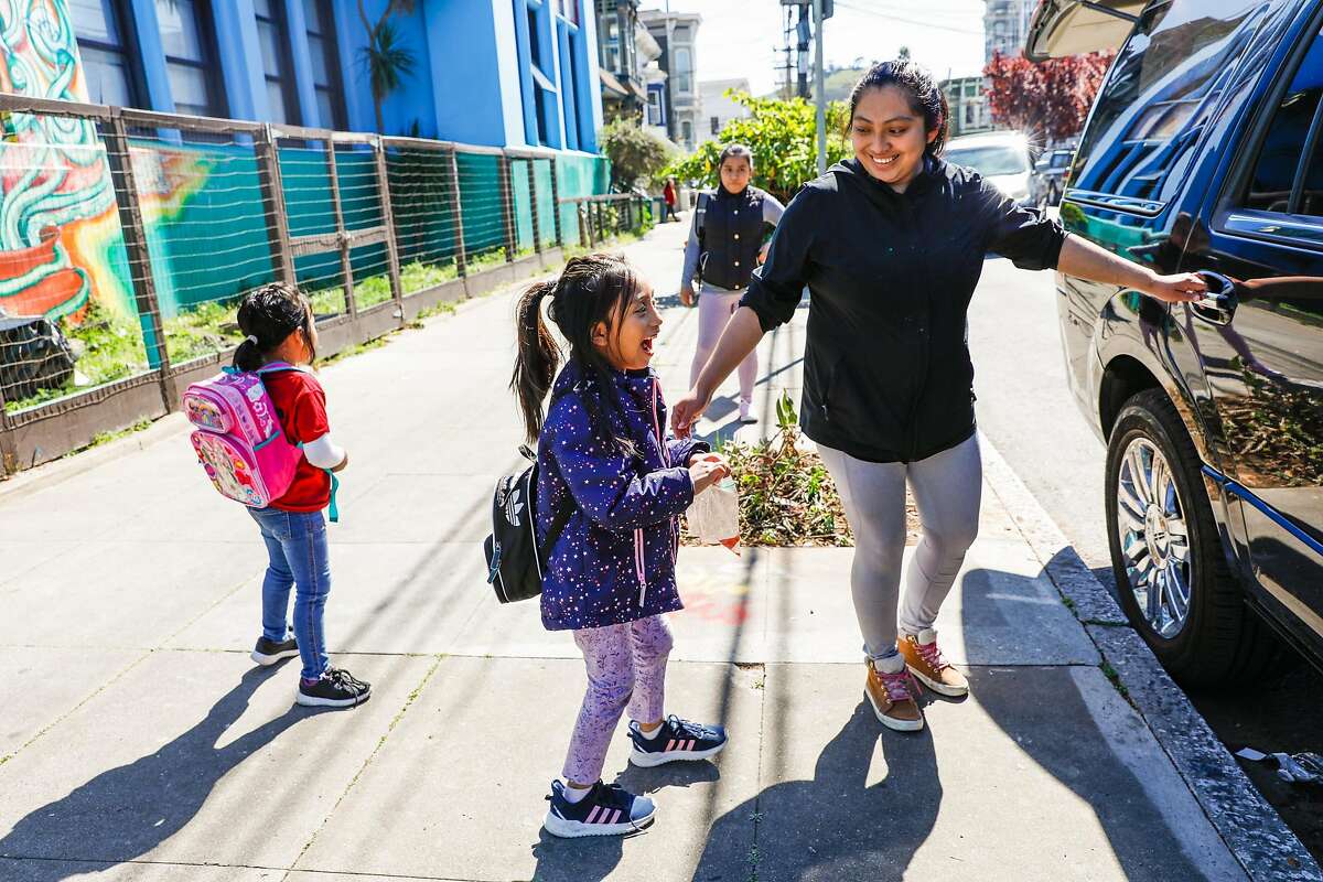 Claudia Mendez (right) picks up daughter Natalie Cetina, 6 (left) from Cesar Chavez Elementary School on Thursday, March 12, 2020 in San Francisco, California. There are concerns with keeping schools open as the coronavirus continues to spread throughout the country and California.