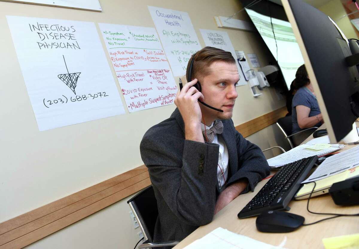 Dr. David Gaston, infectious disease clinical fellow, answers calls at the Covid-19 call center at Yale New Haven Hospital on March 12.
