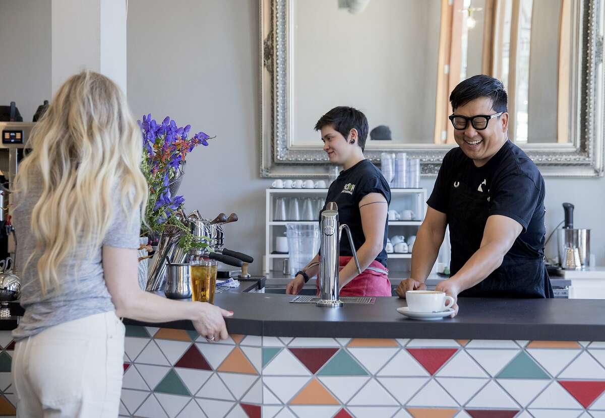Wrecking Ball Coffee founder and owner Nick Cho (right) works behind the counter to create drinks at his shop along Shattuck Avenue in Berkeley, Calif. Tuesday, September 17, 2019.
