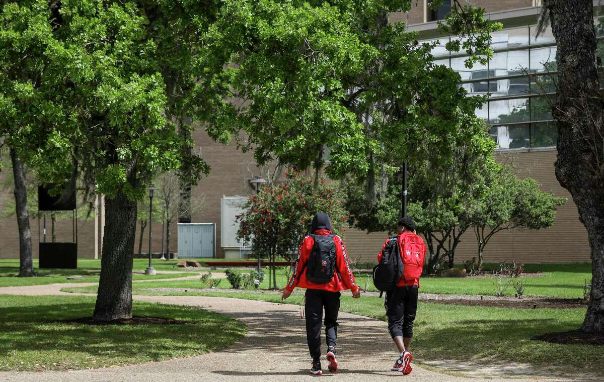 Houston Cougars guard Caleb Mills (2), left, and guard Marcus Sasser (0) walk through campus after they returned with the rest of their team on Thursday, March 12, 2020, at the University of Houston in Houston. The team, which was heading to Fort Worth for the American Athletic Conference Championship, returned to the university after receiving news of the cancellation of the tournament this morning, due to concerns about COVID-19.
