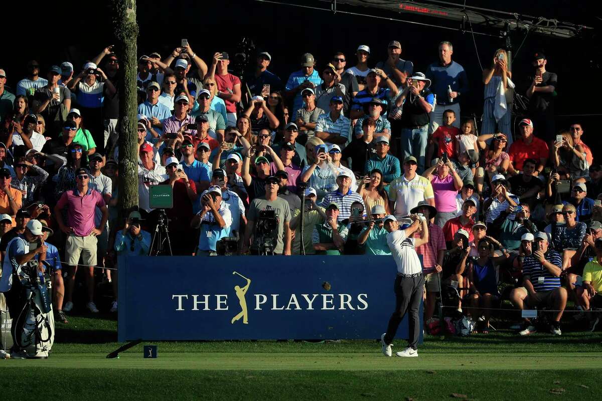 Fans crowd the 17th hole to see who can hit the island green, but they won’t be able to watch Rory McIlroy and others give it a shot for the final three rounds of The Players Championship in Ponte Vedra Beach, Fla.