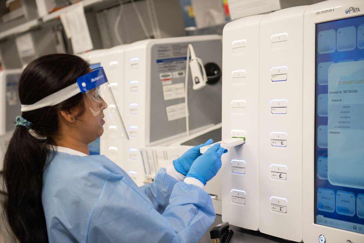 LAKE SUCCESS, NY - MARCH 11: A lab technician begins semi-automated testing for COVID-19 at Northwell Health Labs on March 11, 2020 in Lake Success, New York. An emergency use authorization by the FDA allows Northwell to move from manual testing to semi-automated. (Photo by Andrew Theodorakis/Getty Images)