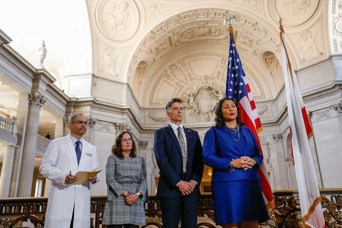 (L-r) Dr. Tomas Aragon, Mary Ellen Carroll, Dr. Grant Colfax and Mayor London Breed listen during a press conference to announce a state of emergency due to the global outbreak of the coronavirus at City Hall on Tuesday, Feb. 25, 2020 in San Francisco, California.