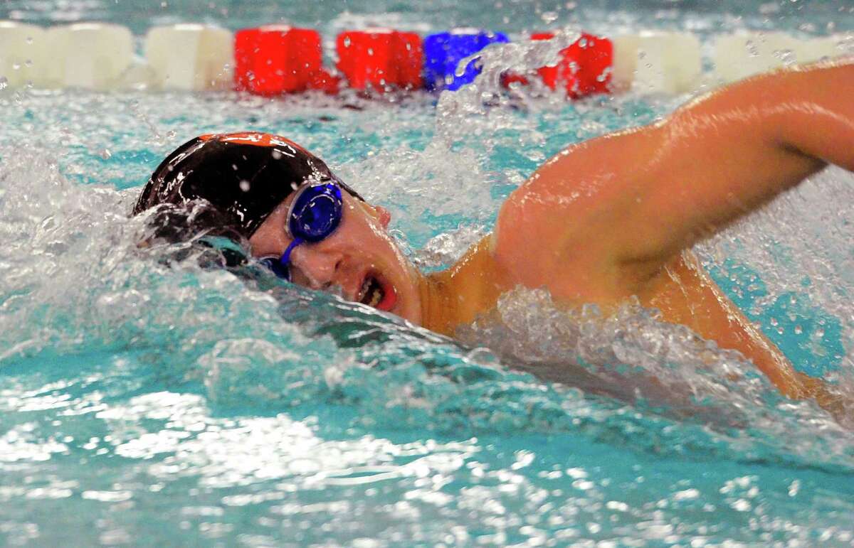 Ridgefield’s Kai O’Malley competes in the 200-yard freestyle during the FCIAC boys swimming championship meet last Thursday.