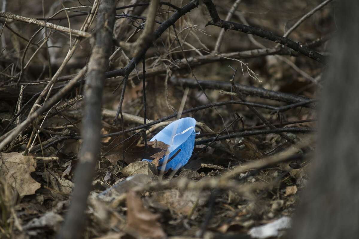 A protective mask is seen on the ground near a COVID-19 testing tent which is set up outside of the Emergency Department at MidMichigan Medical Center-Midland Friday, March 13, 2020. (Katy Kildee/kkildee@mdn.net)