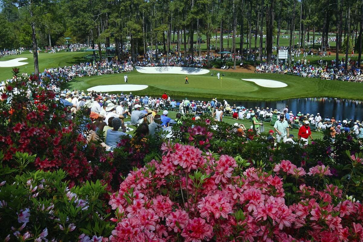 FILE - In this April 4, 2011, file photo, golf fans watch practice on the par three 16th hole during a practice round for the Masters at Augusta National Golf Club in Augusta, Ga. Augusta National decided Friday, March 13, 2020, to postpone the Masters because of the spread of the coronavirus. Club chairman Fred Ridley says he hopes postponing the event puts Augusta National in the best position to host the Masters and its other two events at some later date. Ridley did not say when it would be held. (Tim Dominick/The State via AP, File)
