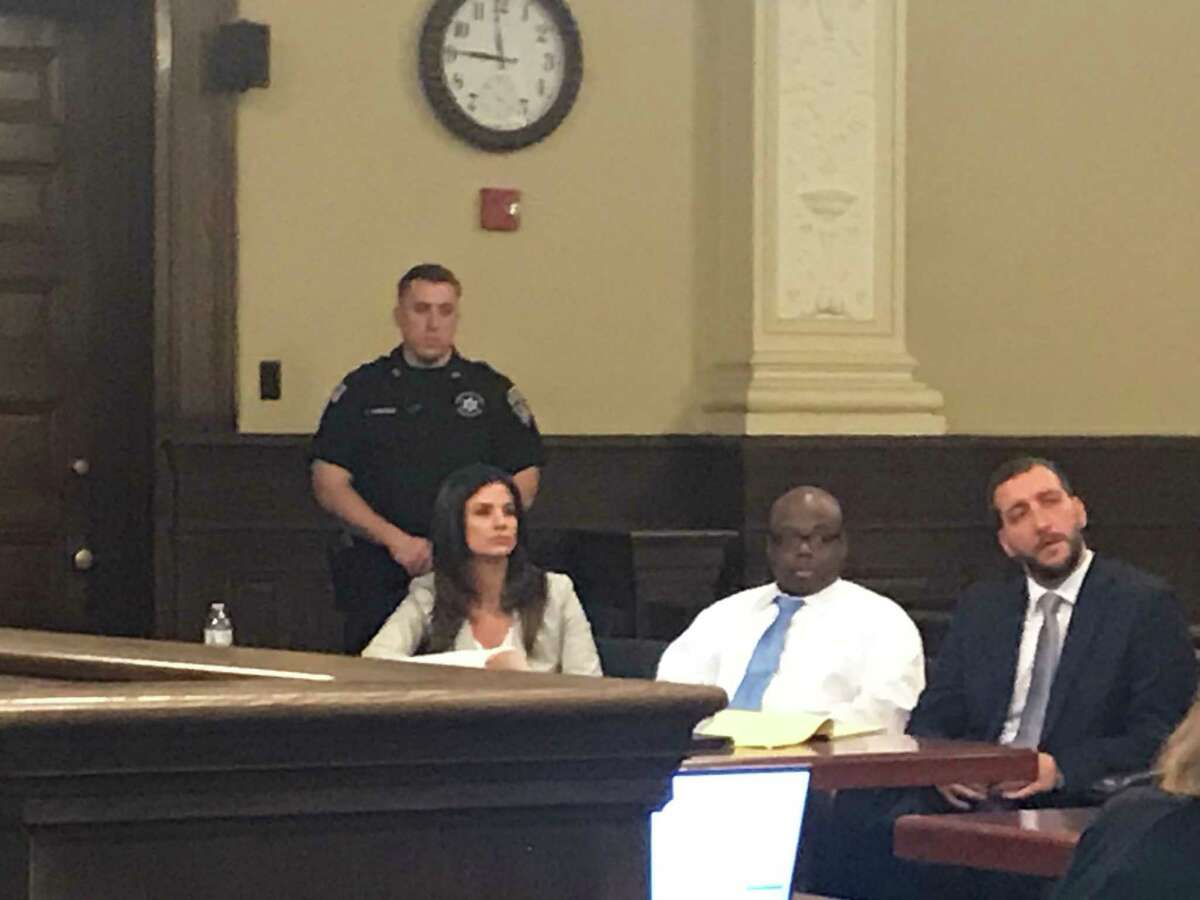 Law clerk Terry D'Aloia, defendant James White and defense attorney Kurt Haas listen as Assistant District Attorney Cheryl McDermott delivers her opening statement duringWhite's quadruple homicide trial in Rensselaer County Court on Friday, March 13, 2020.