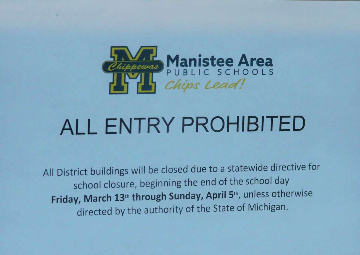 Signs like the one shown adorn all the doorways to the Manistee Area Public Schools after Gov. Gretchen Whitmer closed all Michigan schools on Friday due to the coronavirus. (Ken Grabowski/News Advocate)