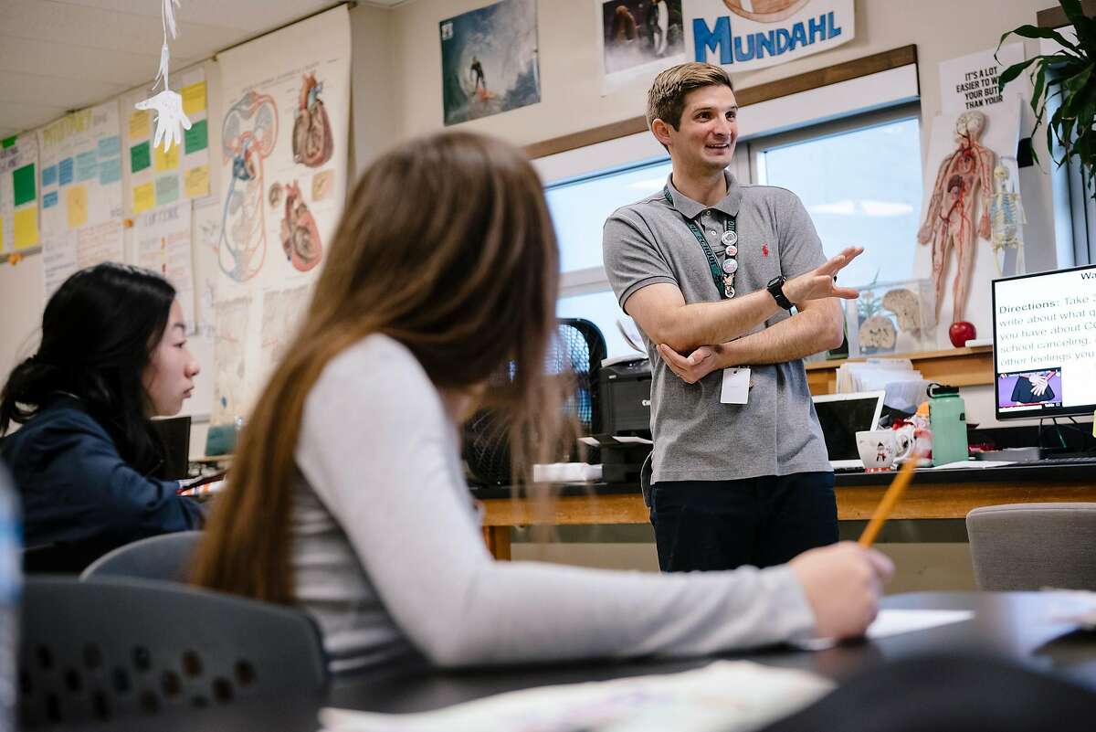 Teacher Evan Mundahl talks with students in his 11th grade Health Sciences class in San Francisco, on March 13, 2020.