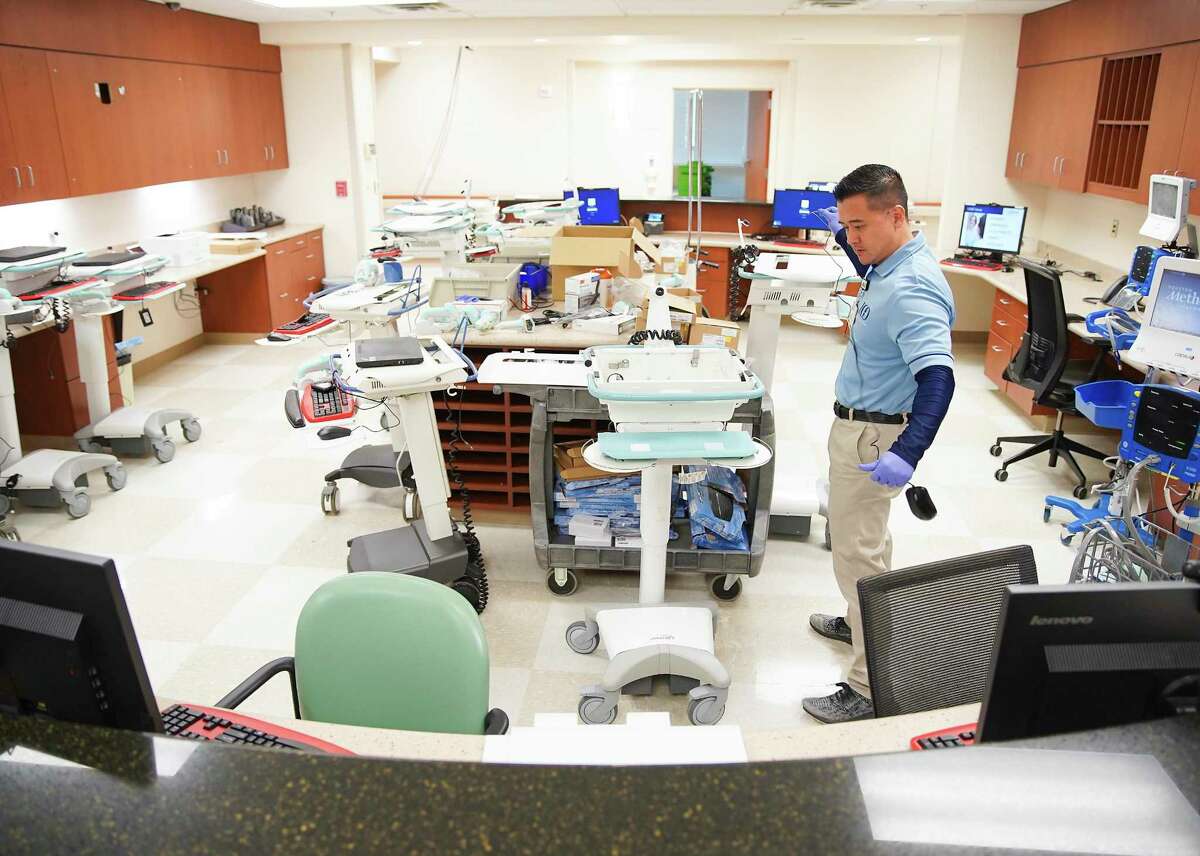 Danny Chang, a senior tech analyst for Houston Methodist, sets up computers on wheels for a special wing at the hospital's Katy campus that will be dedicated to those with coronavirus on Friday, March 13, 2020.