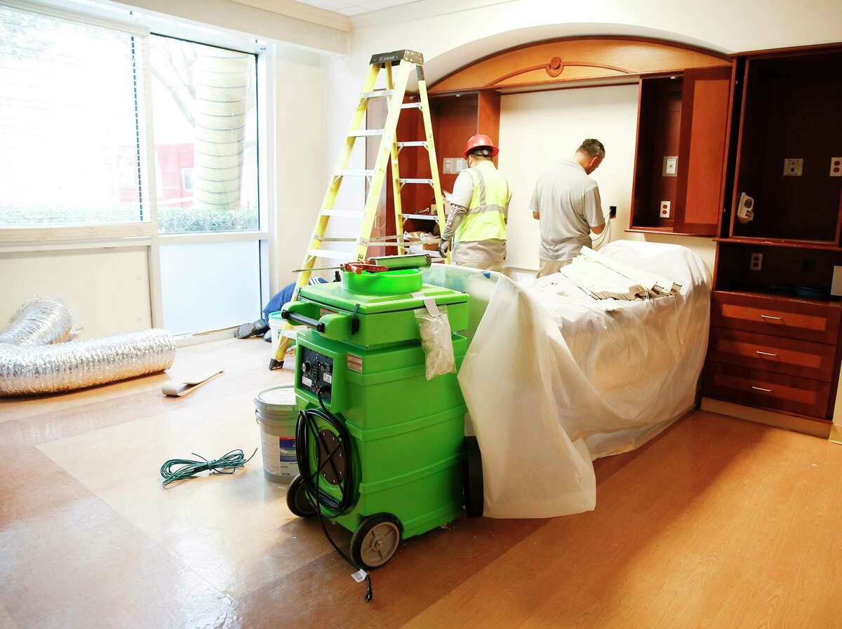 Contractors put the final details on a room at Houston Methodist in Katy that will be dedicated to those with coronavirus on Friday, March 13, 2020.