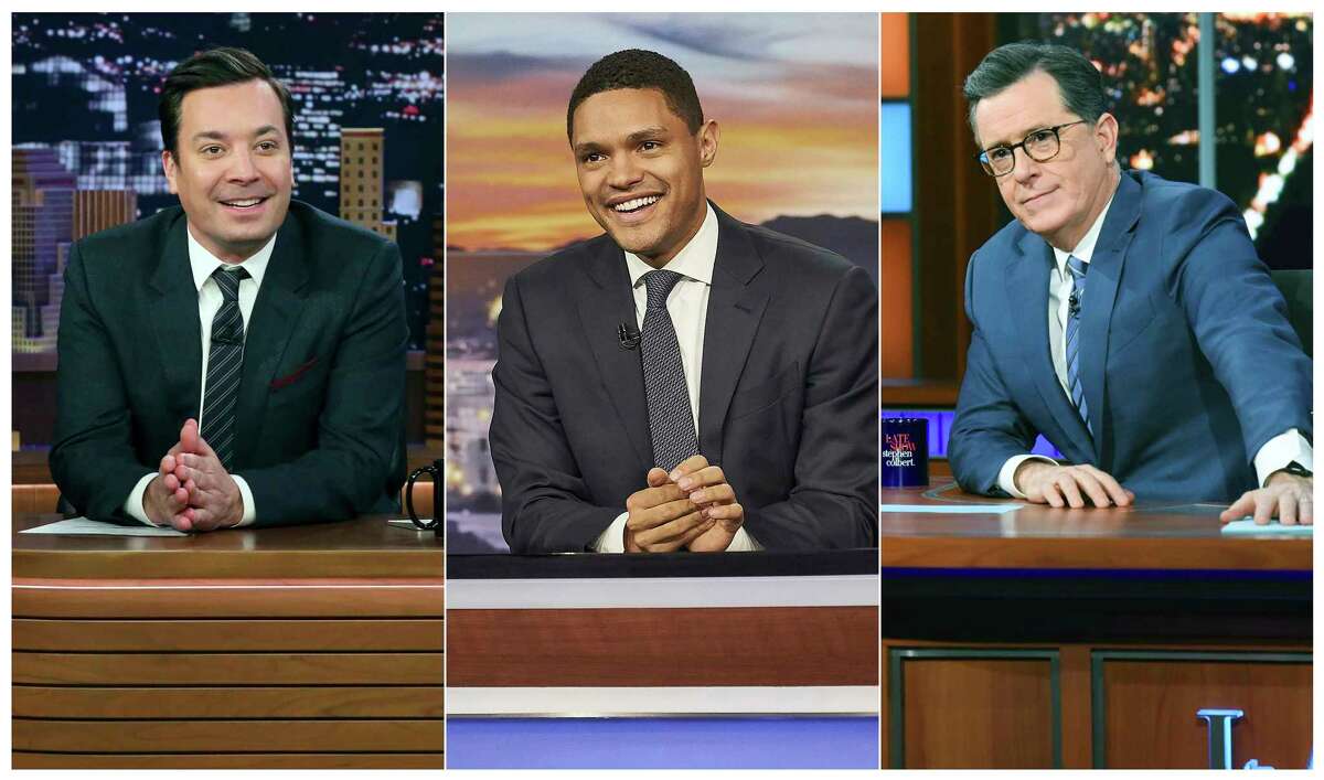 This combination of photos show, from left, host Jimmy Fallon on the set of "The Tonight Show with Jimmy Fallon," on Feb. 3, 2020, from left, host Trevor Noah on the set of "The Daily Show with Trevor Noah and host Stephen Colbert on the set of "The Late Show with Stephen Colbert on Jan. 30, 2020. The late night talk shows announced that they will tape their shows without studio audiences due to the new coronavirus. For most people, the new coronavirus causes only mild or moderate symptoms. For some it can cause more severe illness. (Andrew Lipovsky/NBC, from left, Sean Gallagher/Comedy Central, Scott Kowalchyk/CBS via AP)