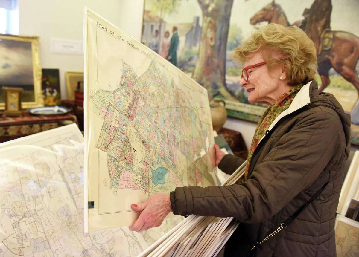 New Canaan resident Mimi Findlay looks at a 1938 map of New Canaan from Paper Duck Antiques at the recent New Canaan Art, Antique and Jewelry Show.