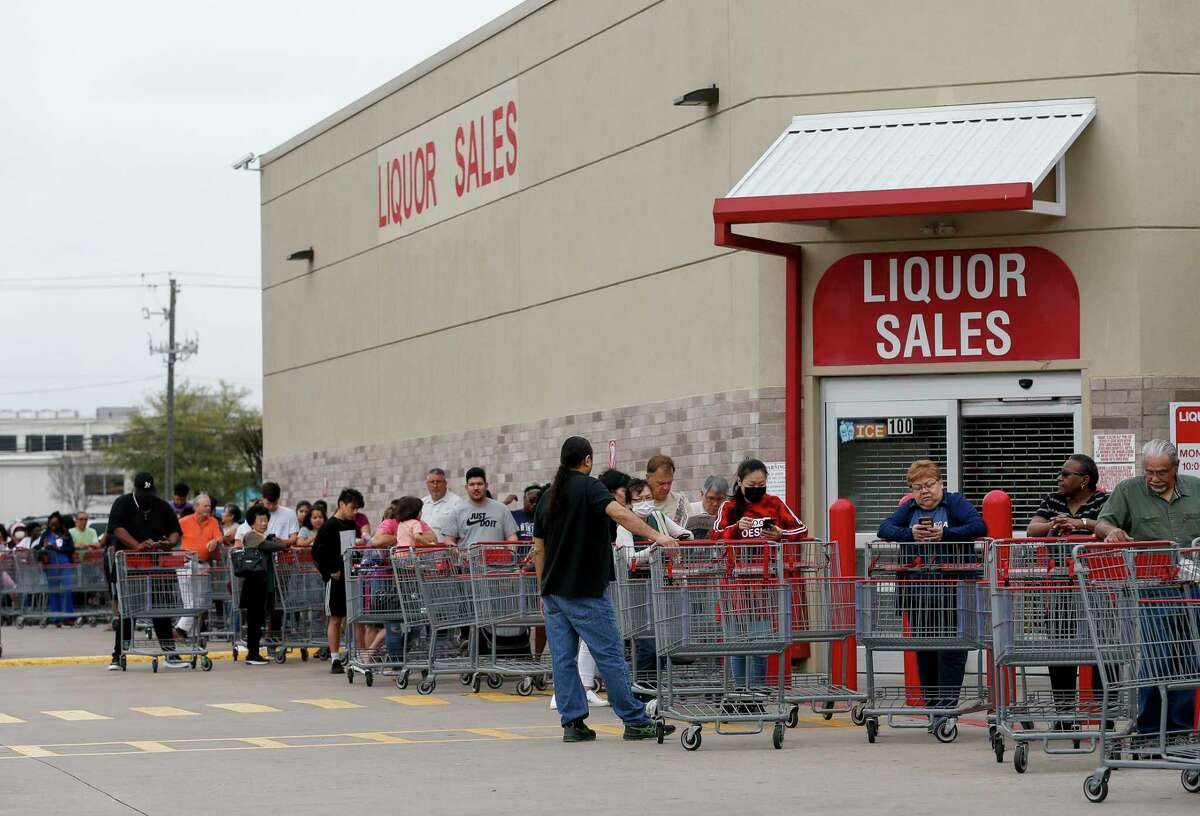 People wait in line for the Costco Wholesale at Bunker Hill Road to open Friday, March 13, 2020, in Houston. People are rushing to grocery stores amid fears of the new coronavirus pandemic.