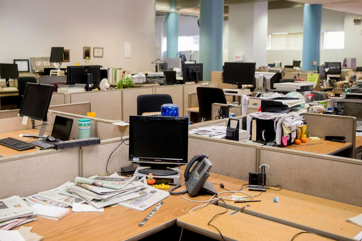 Desks sit empty in the San Francisco Chronicle newsroom on Mission Street in San Francisco, Calif. Saturday, March 14, 2020. For the first time in the newspaper's 155-year history, its editorial staff made the decision to place a mandatory work from home policy on newsroom staff amid the Coronavirus threat.