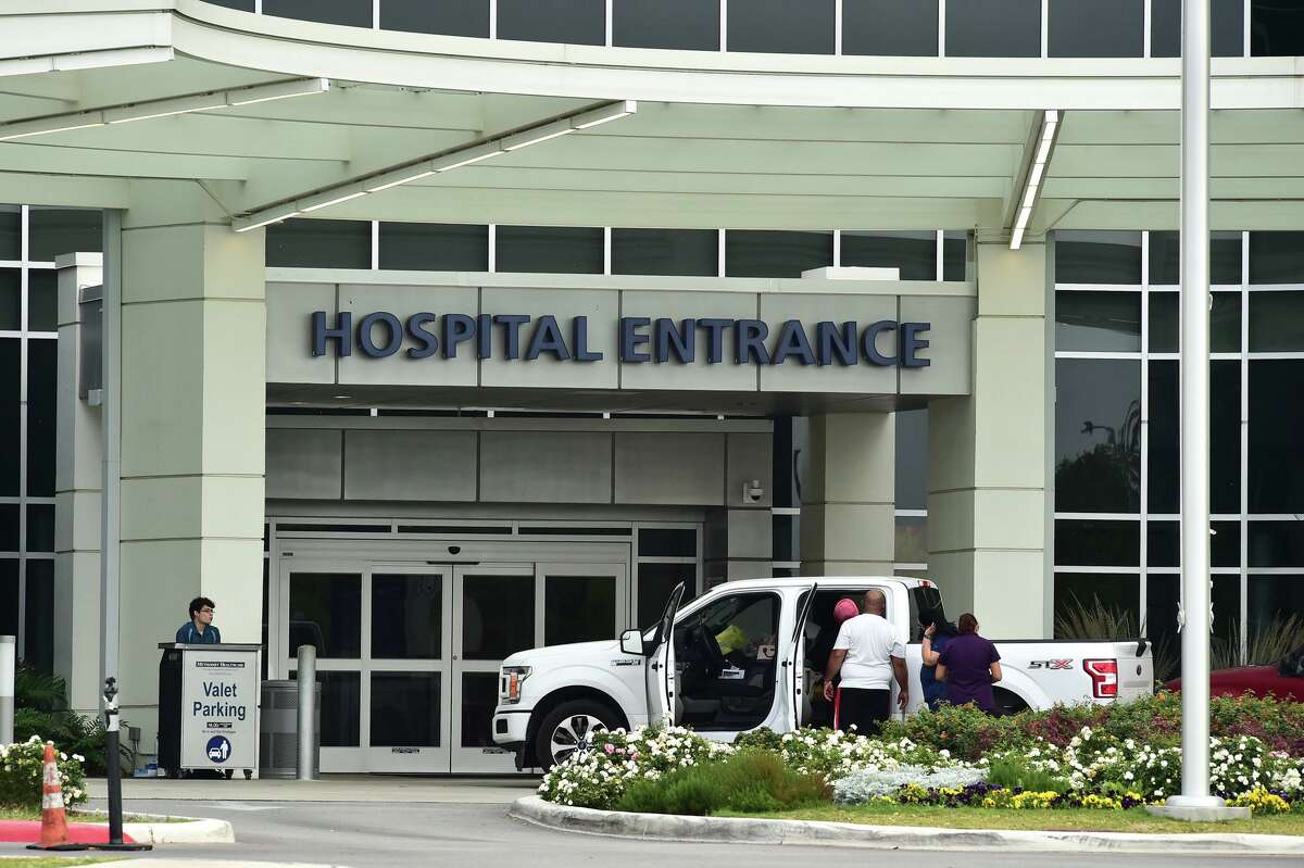 People enter main doors of Methodist Hospital in the Texas Medical Center.