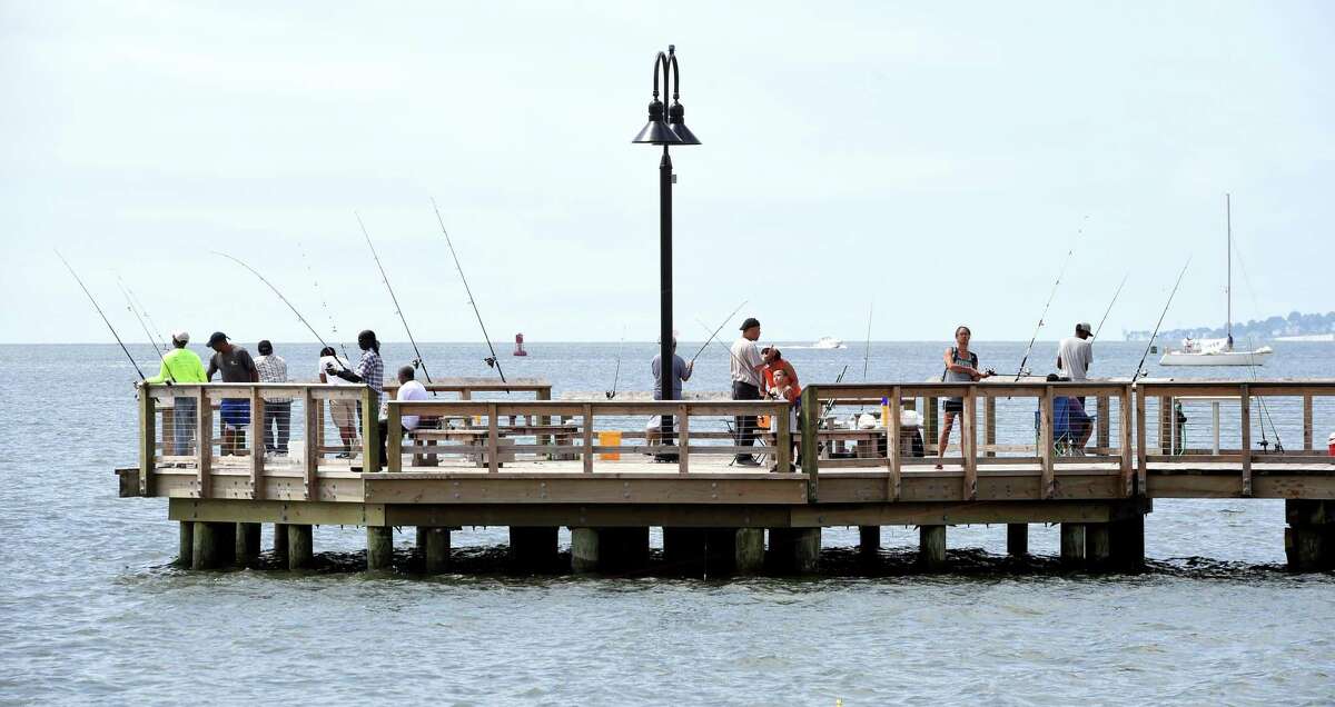 People fish at the rebuilt pier jutting out into New Haven Harbor at Forth Hale Park and Fishing Pier in New Haven on August 17, 2019.