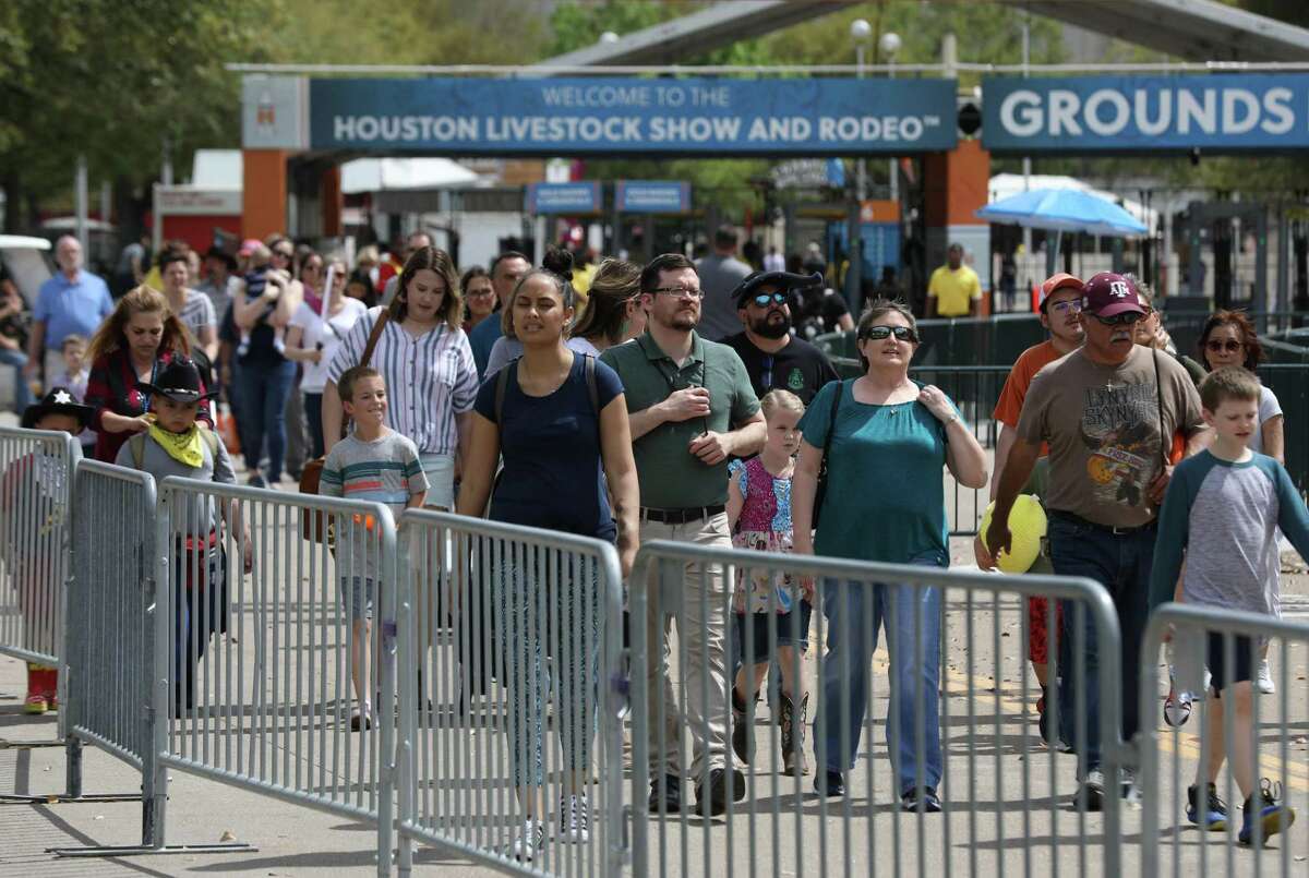 People leave the Houston Livestock Show and Rodeo after its cancellation was announced because of concerns about COVID-19, on Wednesday, March 11, 2020, at NRG Stadium in Houston.