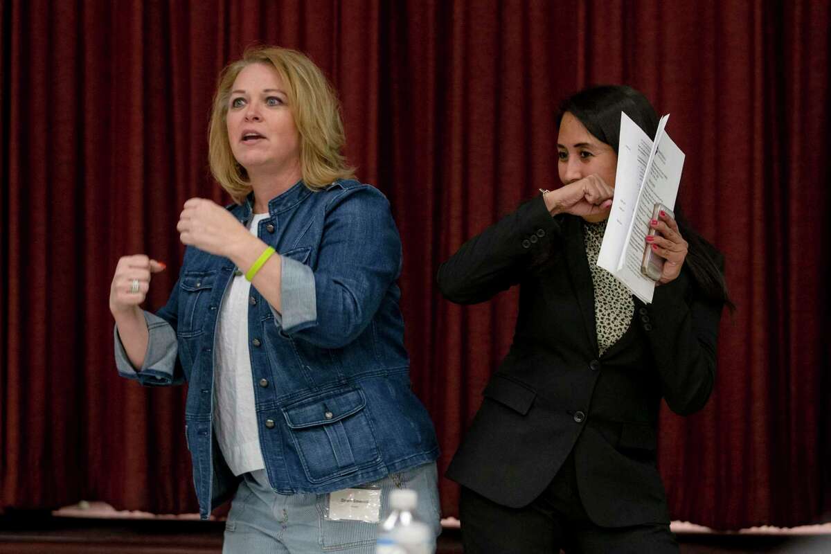 Dr. Dawn Emerick, director of Metro Health, and Councilwoman Adriana Rocha Garcia get ready to demonstrate an elbow bump as an alternative to a handshake to prevent transmission of illnesses during a public forum Feb. 27. San Antonio has now confirmed three cases of COVID-19, all travel-related.