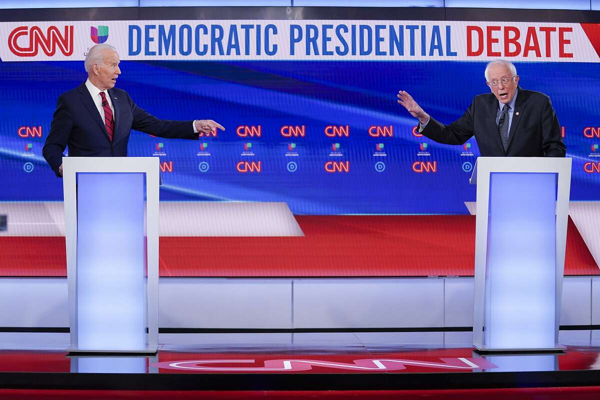 Former Vice President Joe Biden, left, and Sen. Bernie Sanders, I-Vt., right, participate in a Democratic presidential primary debate at CNN Studios in Washington, Sunday, March 15, 2020. (AP Photo/Evan Vucci)