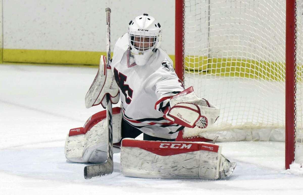 New Canaan goalie Blythe Novick makes a glove save during the Rams' girls ice hockey game against Darien at the Darien Ice House on Saturday, Jan. 4, 2020.