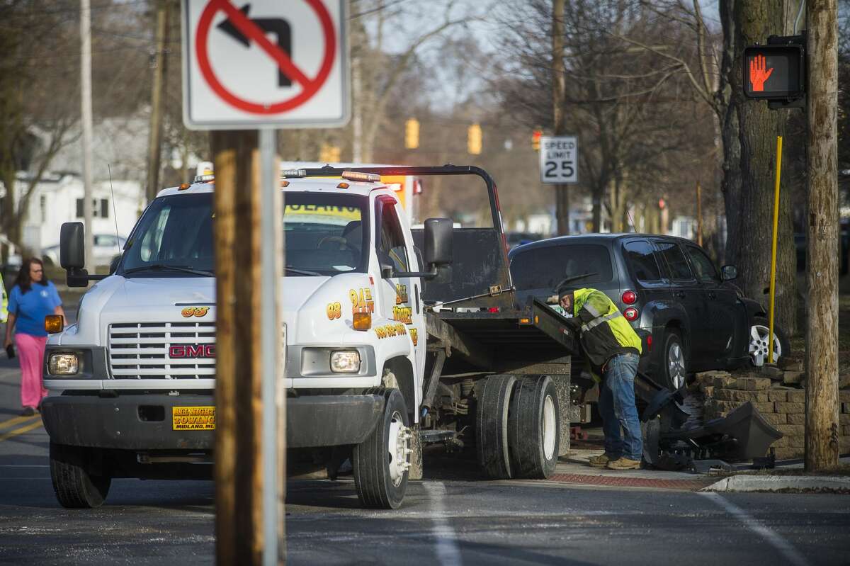 A vehicle is towed away from the scene of a collision at the intersection of Rodd and Carpenter Monday, March 16, 2020 in Midland. (Katy Kildee/kkildee@mdn.net)