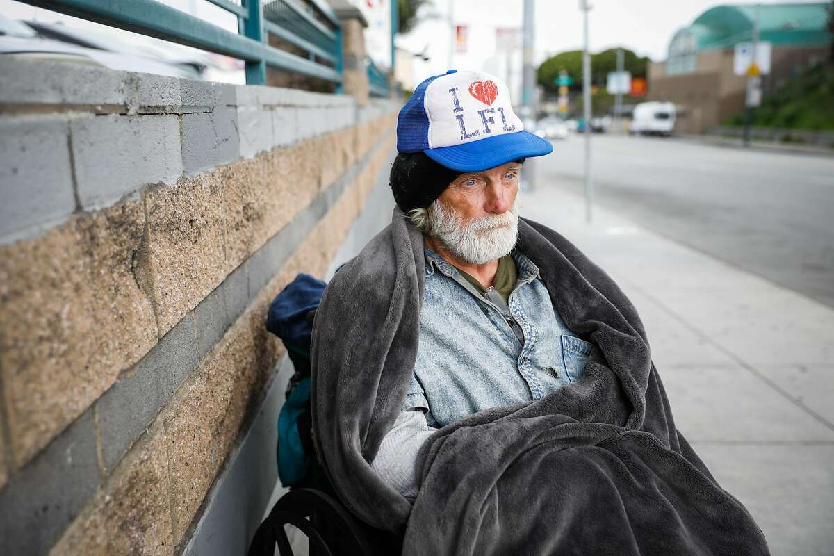 Homeless man Randy Duklin, 64, sits out on 16th Street on Sunday, March 15, 2020 in San Francisco, California.