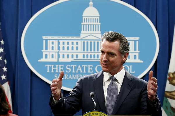 FILE - In this Thursday, March 12, 2020, file photo, California Gov. Gavin Newsom speaks to reporters about his executive order advising that non-essential gatherings of more than 250 people should be canceled until at least the end of March, during a news conference in Sacramento, Calif. Unlike other countries dealing with the coronavirus outbreak, the U.S. has left much of the response to its individual states. The response has been chaotic and led to concerns that the country has missed its golden hour to contain the virus. Now some of them, led by New York Gov. Andrew Cuomo, are calling for the federal government to take a more forceful and coordinated response before it's too late. (AP Photo/Rich Pedroncelli, File)