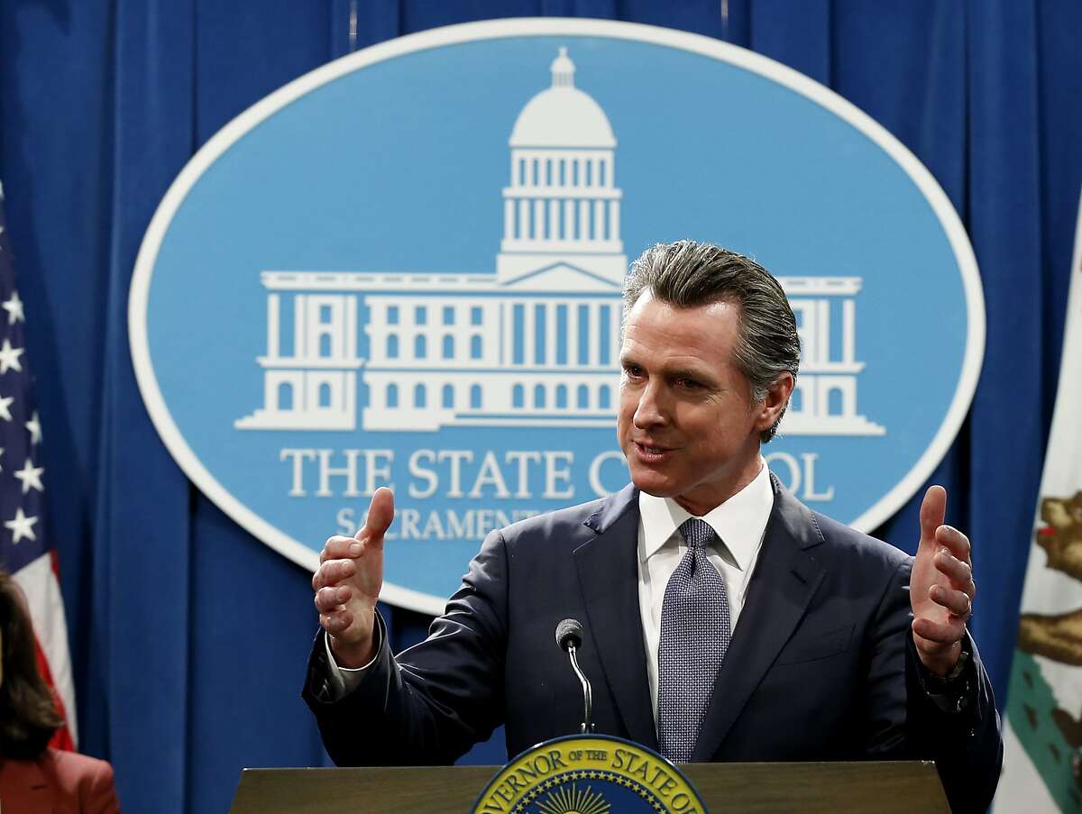 FILE - In this Thursday, March 12, 2020, file photo, California Gov. Gavin Newsom speaks to reporters about his executive order advising that non-essential gatherings of more than 250 people should be canceled until at least the end of March, during a news conference in Sacramento, Calif. Unlike other countries dealing with the coronavirus outbreak, the U.S. has left much of the response to its individual states. The response has been chaotic and led to concerns that the country has missed its golden hour to contain the virus. Now some of them, led by New York Gov. Andrew Cuomo, are calling for the federal government to take a more forceful and coordinated response before it's too late. (AP Photo/Rich Pedroncelli, File)