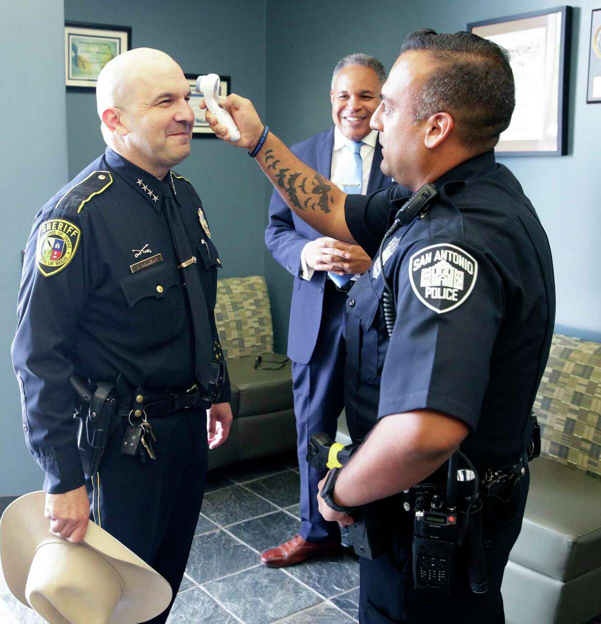 Bexar County Sheriff Javier Salazar has his temperature checked before Gov. Greg Abbott speaks at the San Antonio Operations Center on March 16, 2020. All Bexar County sheriff’s deputies and San Antonio police officers are going through a similar process before they report for work.