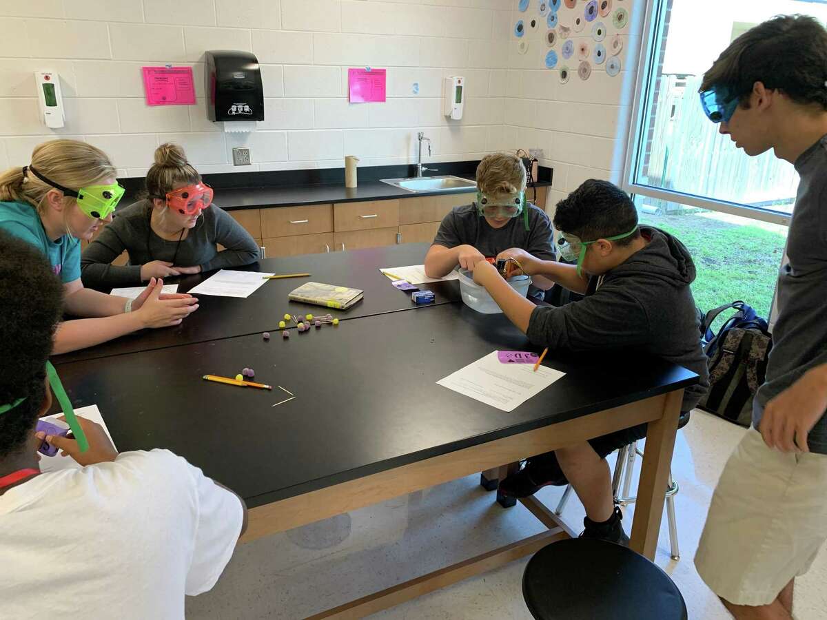 Debra Nolte's Hargrave High School AP Chemistry students teach a lesson to Huffman Middle School eighth graders on Oct. 15