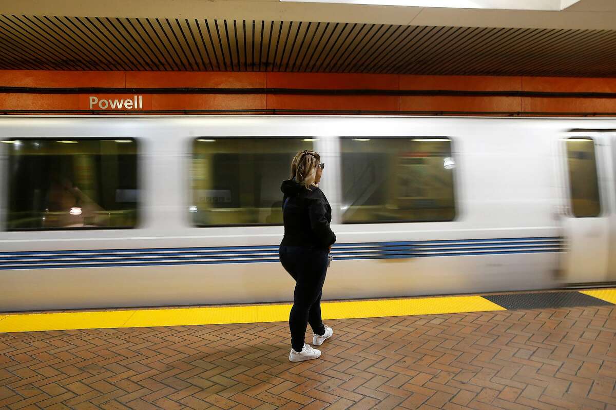 Yulet Pina of San Francisco waits on the platform as a BART train arrives at Powell Street Station on Monday, March 16, 2020 in San Francisco, Calif.