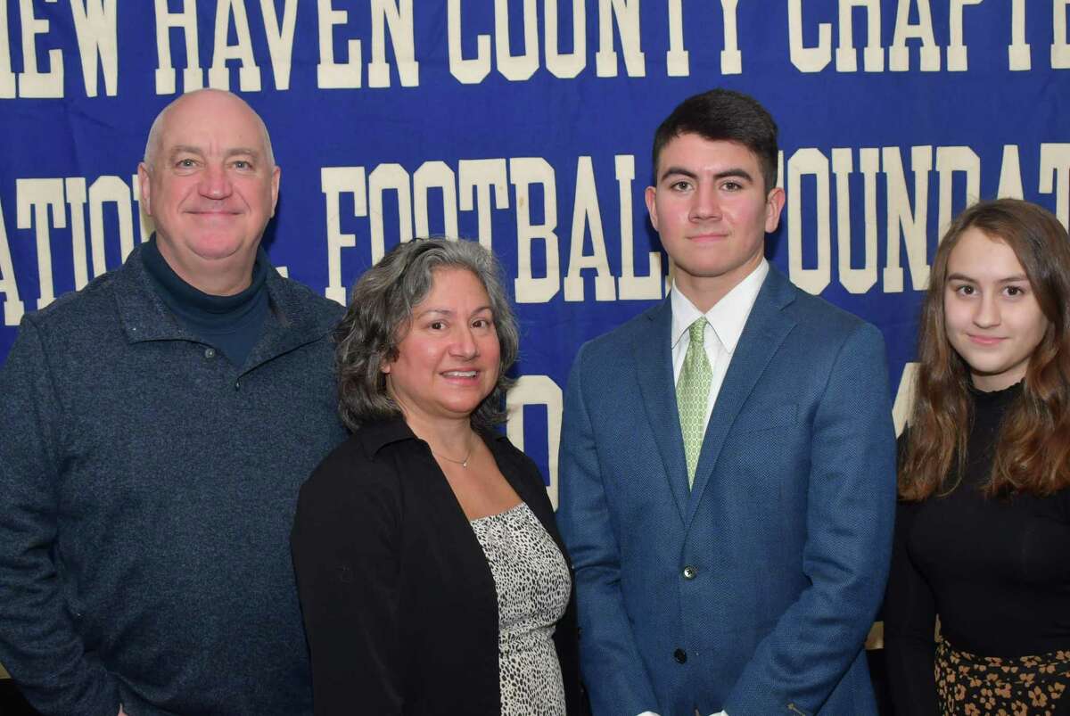Guilford's Evan Russell has been named a scholar athlete by the Casey-O'Brien New Haven County Chapter of the National Football Foundation and College Hall of Fame. He is pictured with his parents John and Anna and sister Maeve.