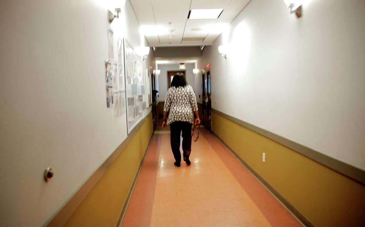 An employee walks the hallway at Houston Area Women's Center in November 2019. The center’s 120-bed shelter has been at capacity throughout the COVID-19 pandemic.