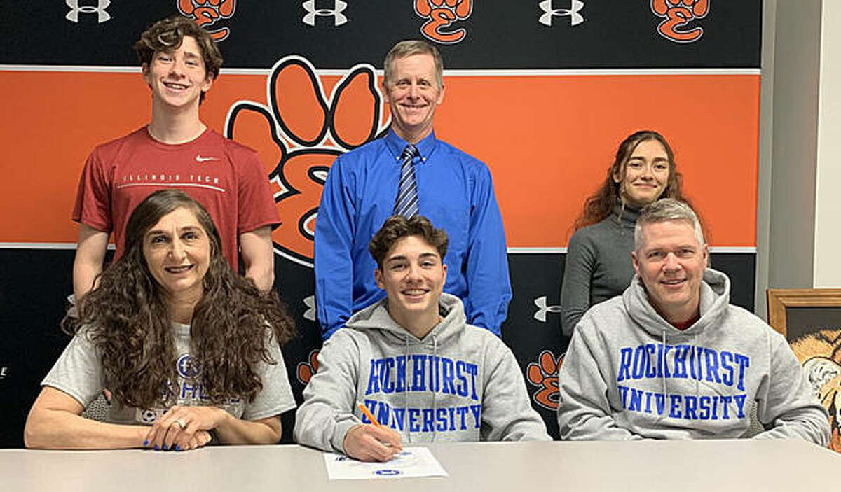 Edwardsville senior Jakob Doyle will play college soccer at Rockhurst University. He is joined by his family and EHS coach Mark Heiderscheid.