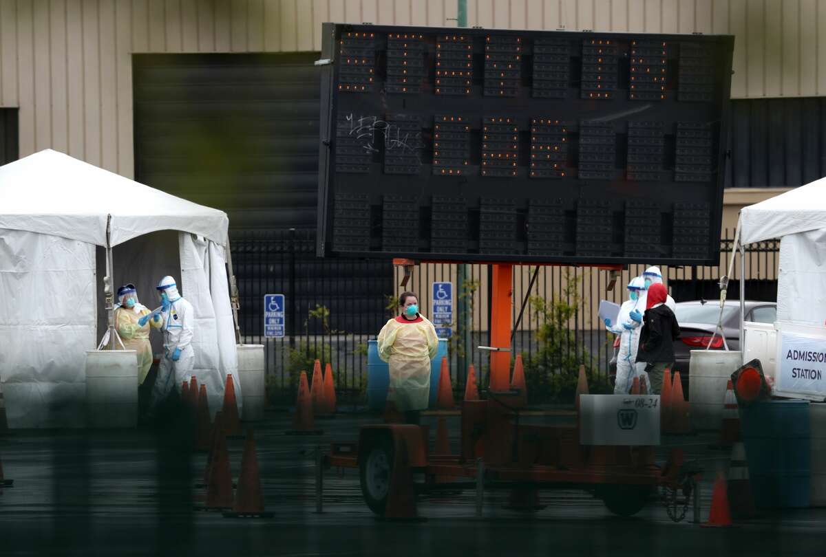 Medical personnel set up a coronavirus drive-thru test clinic at the San Mateo County Event Center on March 16, 2020 in San Mateo, California.
