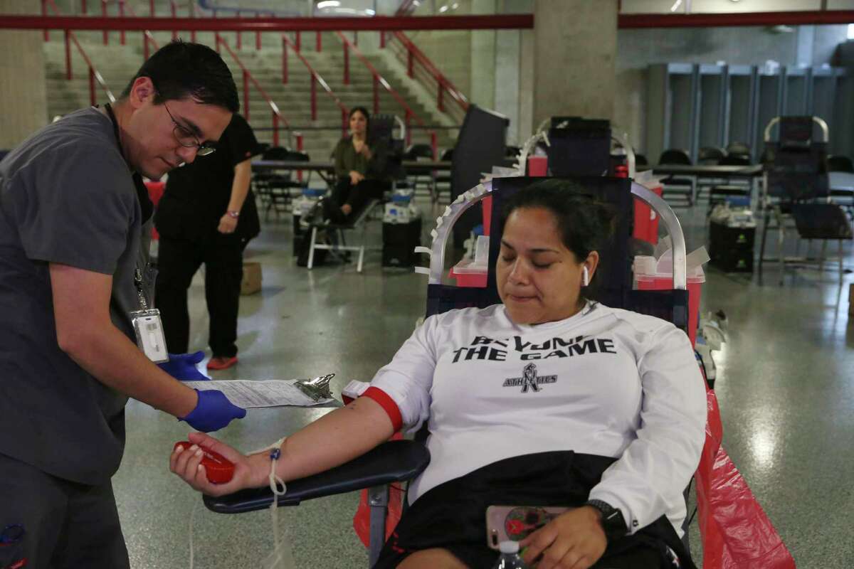 Victor Castillo, 32, sets up Michelle Martinez, 36, who is donating blood Tuesday, March 17, 2020. The city and South Texas Blood and Tissue Center are holding a three-day blood drive at the Alamodome from 9 a.m. to 5 p.m. May 21-23.