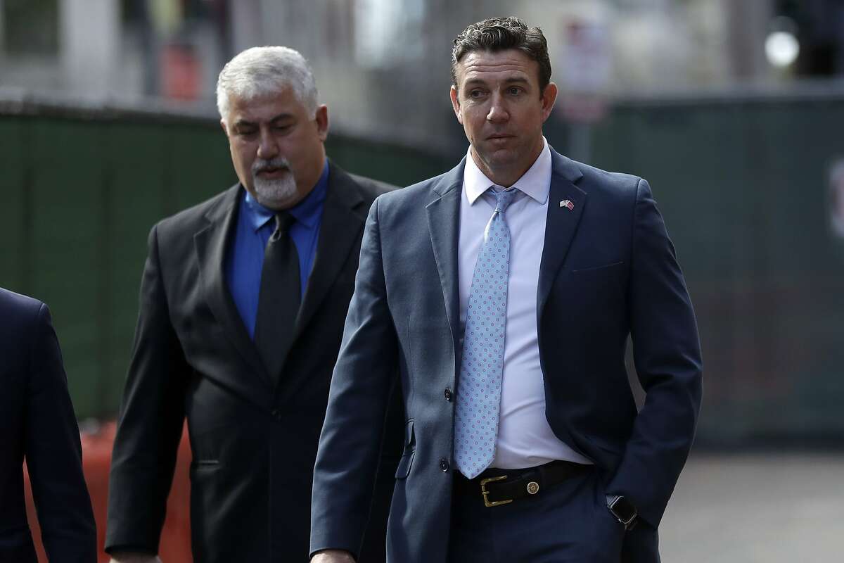 Convicted ex-Rep. Duncan Hunter, right, leaves a court building after sentencing Tuesday, March 17, 2020, in San Diego. Hunter has been sentenced to 11 months in prison after pleading guilty to misspending campaign funds. (AP Photo/Gregory Bull)