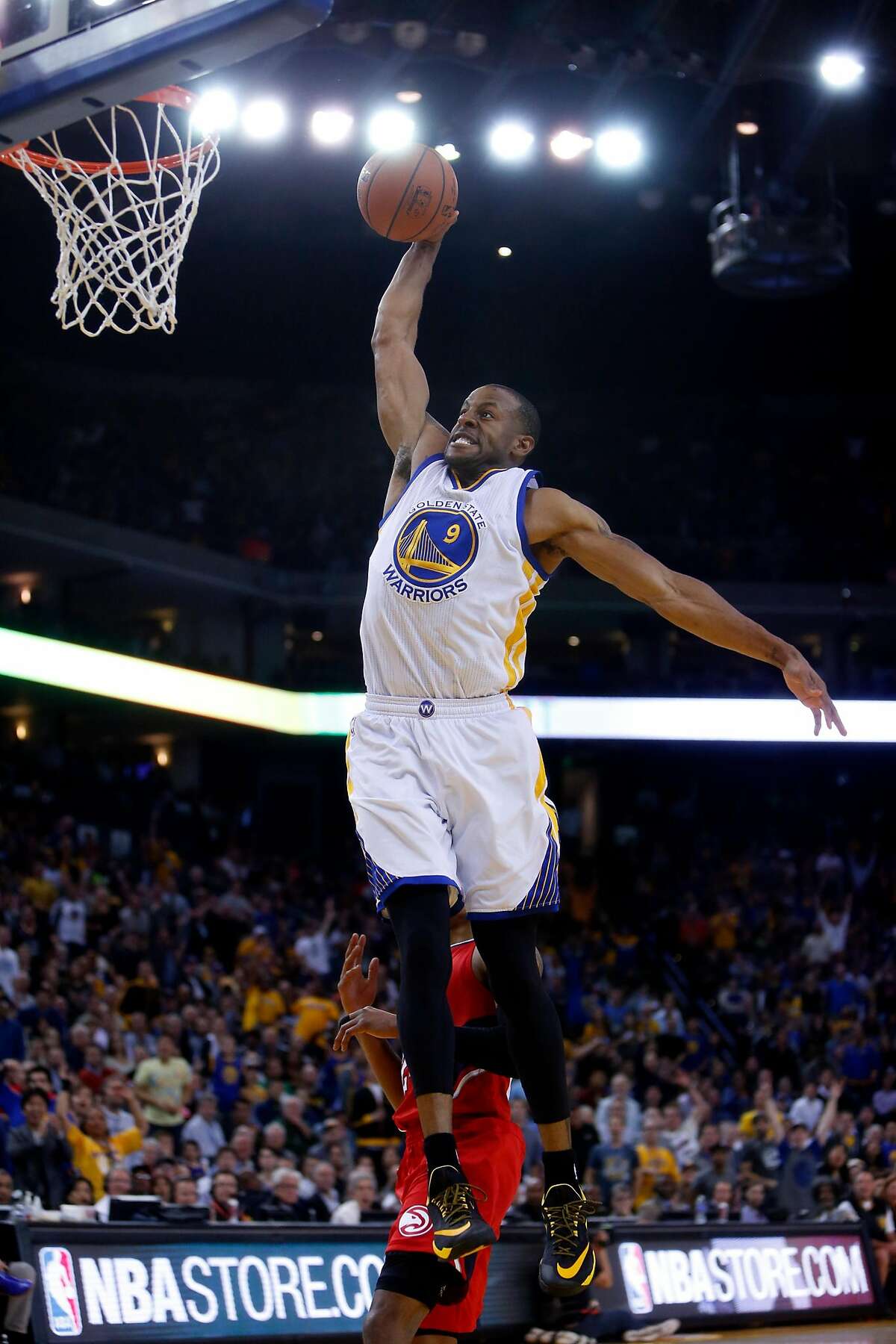 Golden State Warriors' Andre Iguodala dunks against Atlanta Hawks in 4th quarter during NBA game at Oracle Arena in Oakland, Calif., on Wednesday, March 18, 2015.