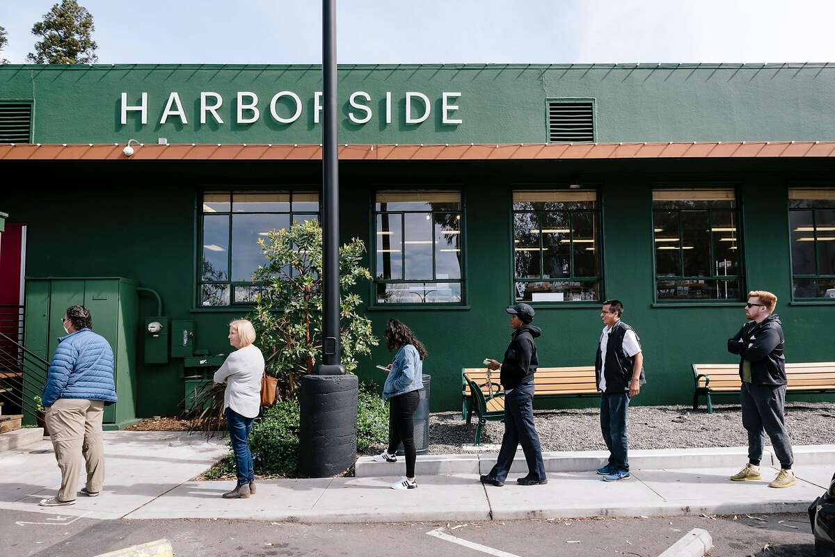 Customers are spaced apart in an effort of social distancing as they line up outside Harborside dispensary in Oakland, California, US, on Tuesday, March 17, 2020.