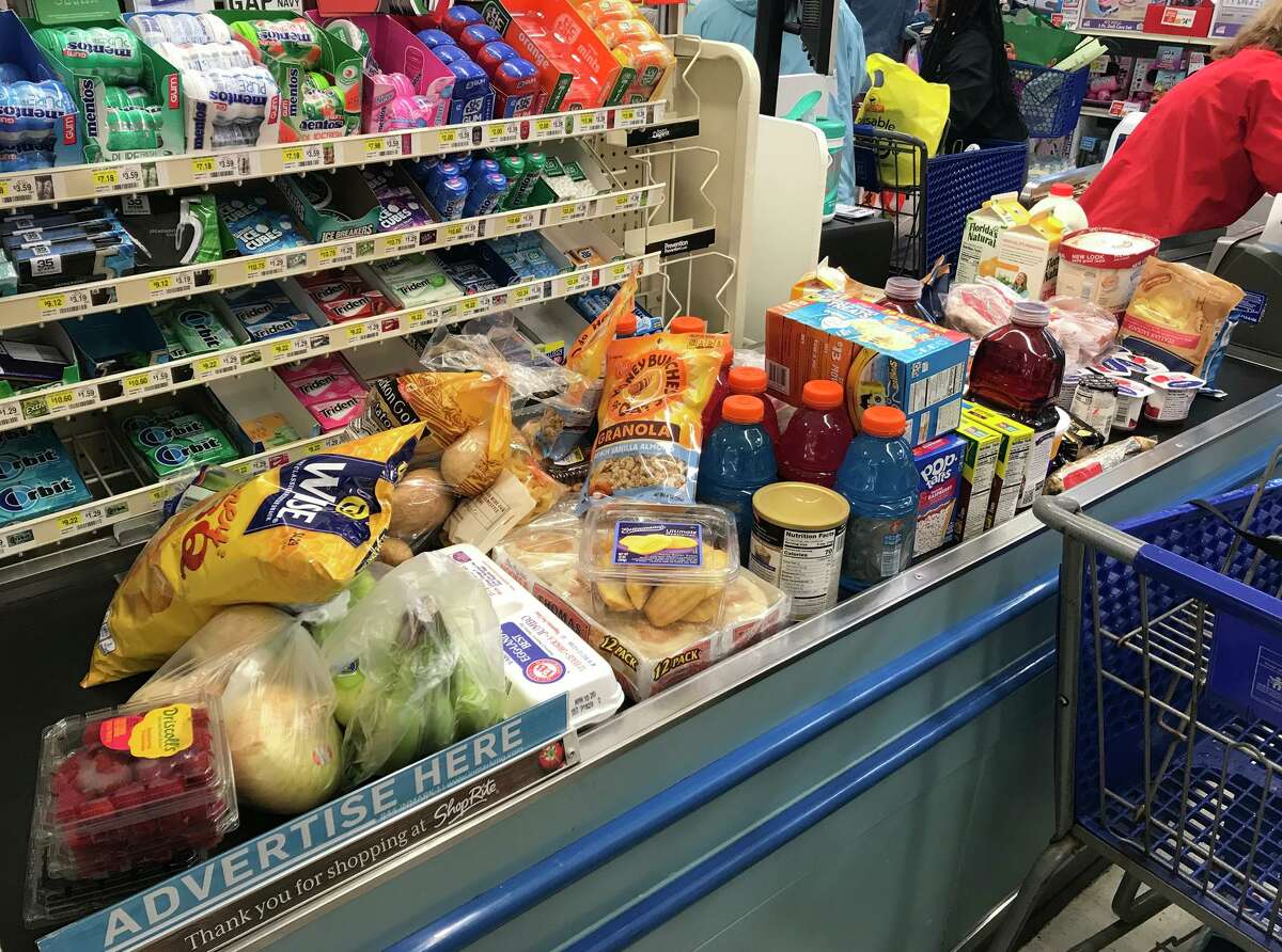 Checkout lines were filled as shopper stocked up on items at ShopRite, in Shelton, Conn. March 13, 2020.