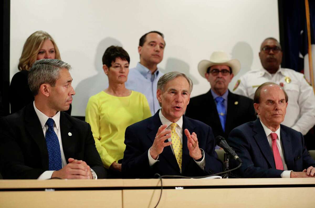 Texas Gov. Greg Abbott, center, is joined by San Antonio Mayor Ron Nirenberg , left, and other state and city officials as he gives an update on the coronavirus outbreak, Monday, March 16, 2020, in San Antonio. (AP Photo/Eric Gay)