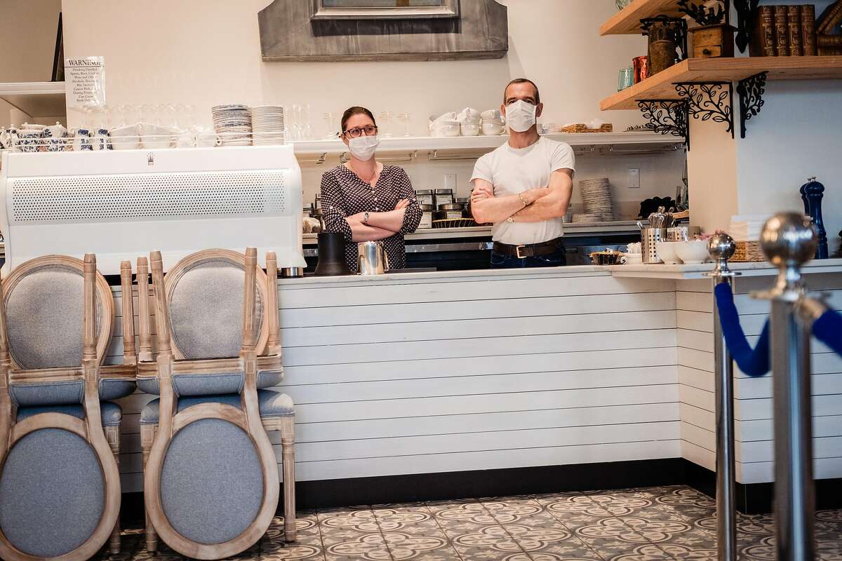 Danel De Betenlu and Magalie Chabot wait for take out orders behind the counter of Maison Danel a cafe on Polk Street that just opened two weeks in San Francisco, Calif. onTuesday, March 17, 2020.
