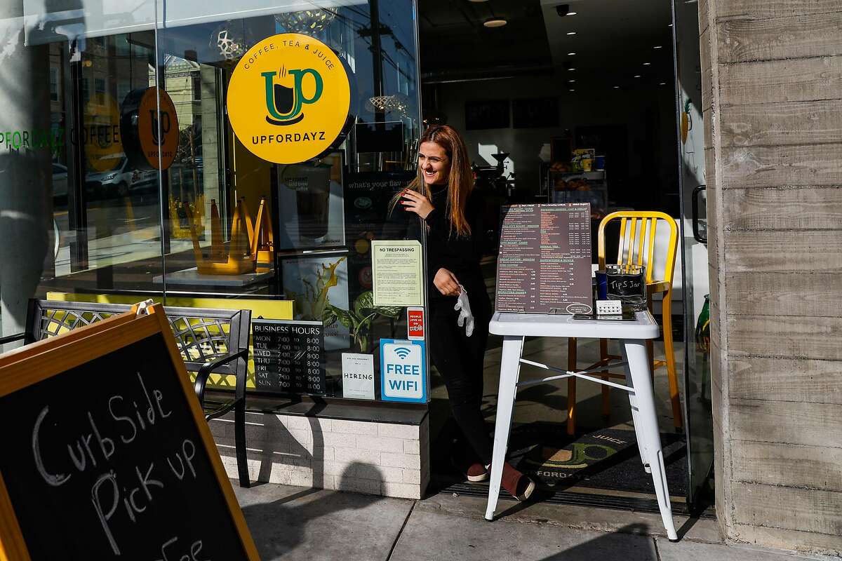 Owner Mera Shamieh at coffee shop UpForDayz Valencia Street on Tuesday, March 17, 2020 in San Francisco, California. The cafe is offering curb side coffee pick up and serving from a window stall.
