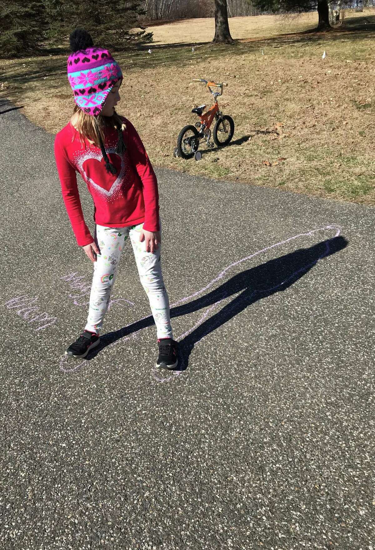 On Monday morning, Maggie Hicks of New Milford joined her family in making body chalk outlines to watch how the sun changes shadows throughout the day, one of the activities the Hicks family planned to keep their children engaged in learning while out of school for an undetermined amount of time.